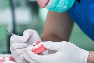 A lab worker making dentures