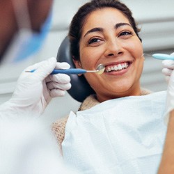Woman smiling at dentist during dental exam