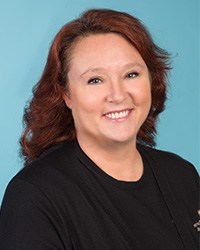 Woman with red hair and a black shirt