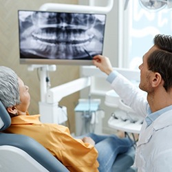 a dentist showing a patient their X ray