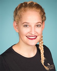 Blonde haired woman wearing red lip stick smiling