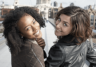 Two females looking back smiling