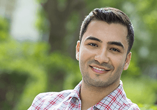 Young man with dark hair smiling