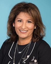 Brown haired woman wearing black scrubs