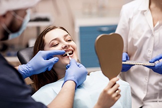 A woman receiving cosmetic dentistry from her dentist