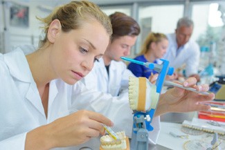 A technician working on a denture