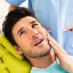 Pained man visiting his Melbourne emergency dentist
