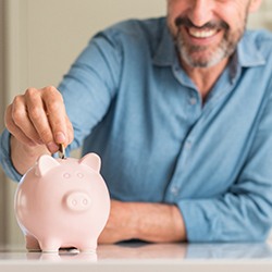 Smiling man saving money to make emergency dental care affordable in Melbourne