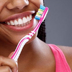 Closeup of smiling woman brushing her teeth