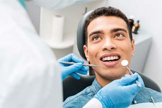Male dental patient with dental implants in Melbourne, FL at dental checkup