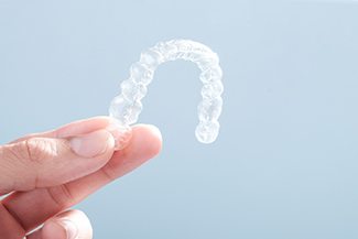 Patient holding SureSmile in Melbourne