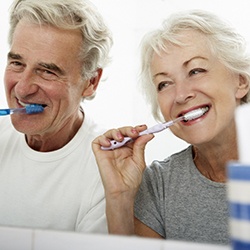 Older couple brushing to prevent dental emergencies in Viera