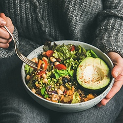 Woman holding a healthy balanced salad