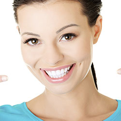 Woman wearing a baby blue shirt smiling