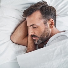 Man sleeping without loud snoring in white bed