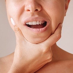 Woman holding her jaw
