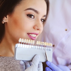 Melbourne cosmetic dentist shade-matching patient's teeth