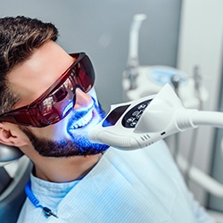 a patient having their teeth whitened at a dental office