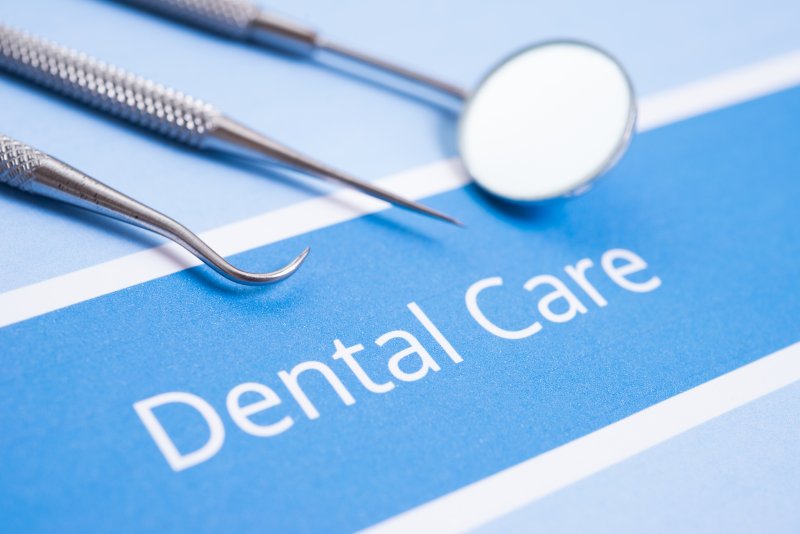 dental instruments and paperwork reading “Dental Care”