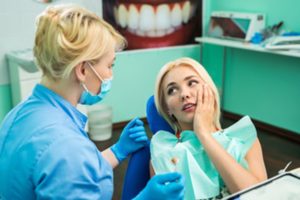 Patient visiting her dentist for a severe toothache.