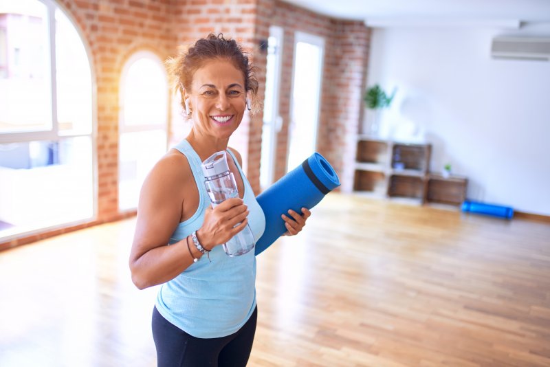 A smiling woman pursuing fitness and oral health