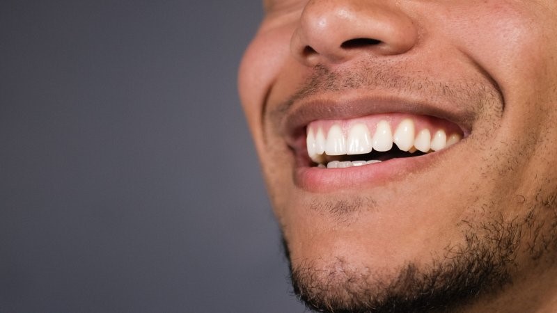 closeup of patient smiling after receiving dental implants  