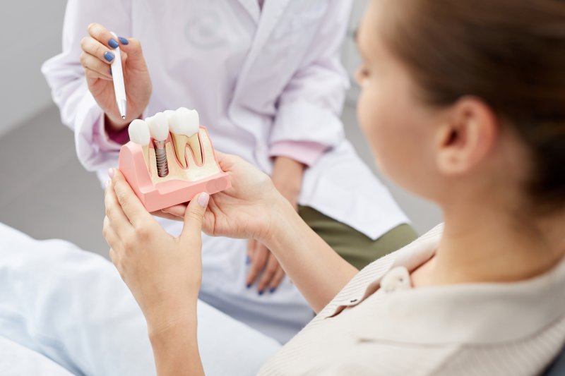 A dentist explaining how implants work to a patient