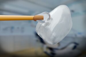 Closeup of cement being applied to a veneer