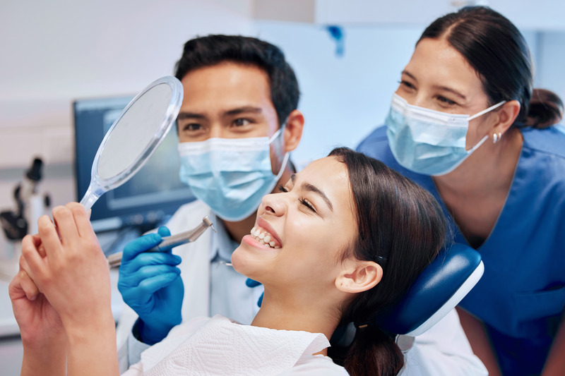 Patient smiling with cosmetic dentist after treatment
