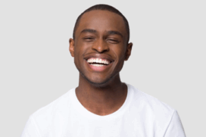 Man smiling widely on a white background