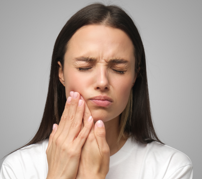 Woman holding jaw in pain