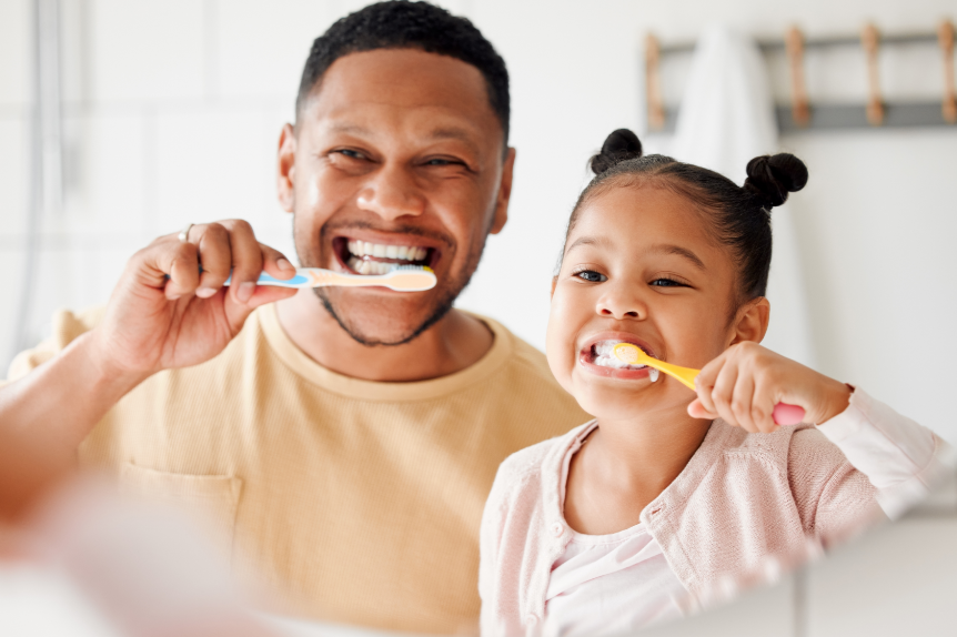 Dad and daughter brushing teeth